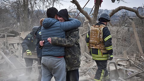 Local residents react at the site of Russia's air attack, in Zaporizhzhia, Ukraine, Friday, March 22, 2024