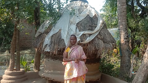 Ashalata Ray stands near her house 
