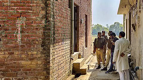 Security personnel deployed outside the residence of Sajid, who allegedly killed two boys on Tuesday, at Sakhanu village in Budaun district, Wednesday, March 20, 2024.