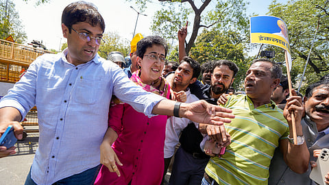 Delhi Minister and AAP leader Atishi Singh with party workers and supporters at Shaheedi Park during a protest over the arrest of Delhi Chief Minister Arvind Kejriwal in connection with an excise policy-linked money-laundering case, in New Delhi.