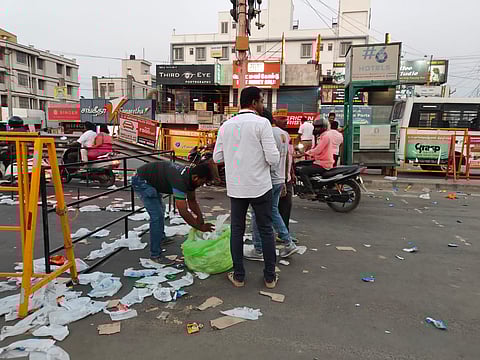 Workers cleaning the road after PM Modi's road show.