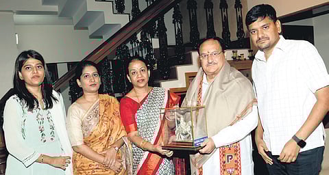 BJP national president JP Nadda is welcomed by party MP Mangala Suresh Angadi, as Shraddha Shettar, her husband Sankalp Shettar, and Spoorthi Patil, look on, at the Angadi residence in Belagavi on Wednesday 