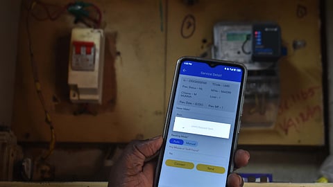 A TANGEDCO assessor taking reading from a meter using the BTP at a shop in Coimbatore.