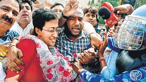 Delhi cabinet minister Atishi with AAP workers being detained during a protest at the ITO crossing on Friday