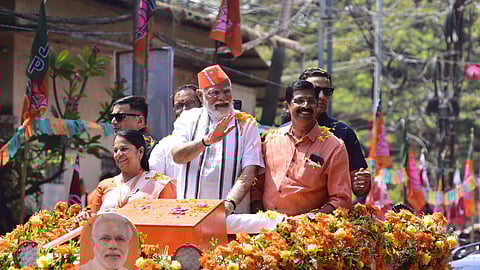 Prime Minister Narendra Modi waves to supporters during a roadshow, ahead of the upcoming Lok Sabha election, in Palakkad on March 19, 2024. 