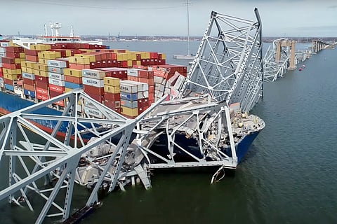 The cargo ship Dali is stuck under part of the structure of the Francis Scott Key Bridge after the ship hit the bridge.