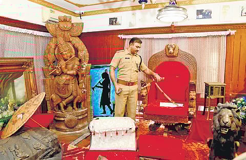 A crime branch official searching the rented house of Monson Mavunkal at Kaloor in Kochi.