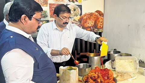 Food safety officials inspect food at a hotel to check the use of artificial colouring agents in food in Chennai on Wednesday.