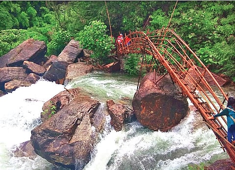 Mawryngkhang bamboo bridges across a waterfall