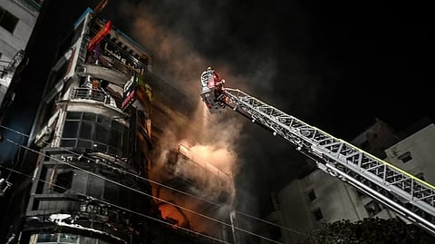 Firefighters work to extinguish a fire in a commercial building that killed at least 43 people, in Dhaka