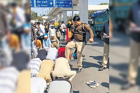 A Delhi Police sub-inspector seen kicking a person offering namaz on a road in Inderlok area on Friday. The cop’s action drew widespread flak