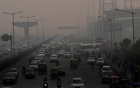 Vehicles ply on a road amid low visibility due to smog, in Ghaziabad.