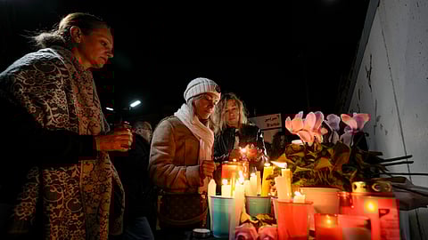 Women light candles outside the Russian embassy in Beirut, Lebanon, Saturday, March 23, 2024 to show their solidarity with the victims of an attack Friday on the Crocus City Hall on the western edge of Moscow.