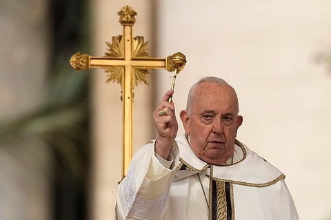 Pope Francis asperses holy water as he celebrates Easter mass in St. Peter's Square at the Vatican, Sunday, March 31, 2024.