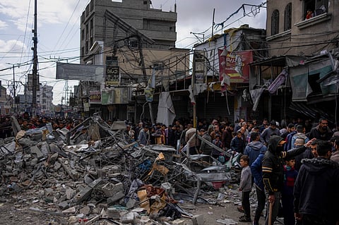 Palestinians check destruction after an Israeli strike in Rafah, Gaza Strip.