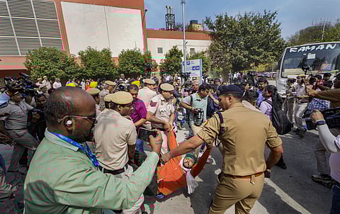 Security personnel detain AAP workers during their protest outside Patel Chowk metro station against the arrest of Delhi CM Arvind Kejriwal, in New Delhi, Tuesday, March 26, 2024.
