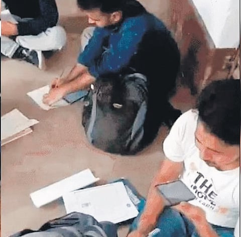A video footage of candidates, allegedly filling up their OMR sheets sitting on the floor outside their examination halls in Jamtara also went viral on social media.