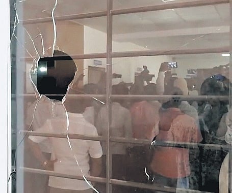 A window damaged by supporters of MP Karadi Sanganna