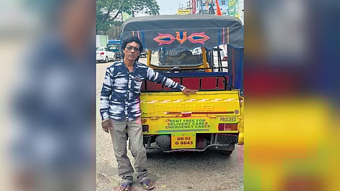 Gagan Patra with his autorickshaw in Berhampur