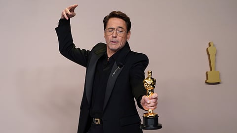 Robert Downey Jr. poses with the award for best performance by an actor in a supporting role for "Oppenheimer" in the press room at the Oscars on Sunday, March 10, 2024, at the Dolby Theatre in Los Angeles.