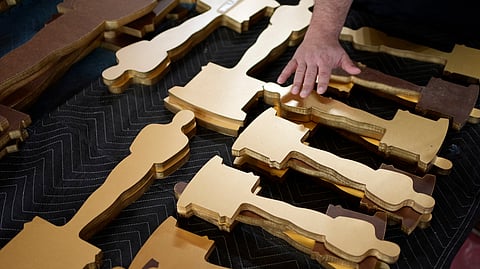 Oscars statue cutouts rest on a table along the red carpet ahead of the 96th Academy Awards Friday