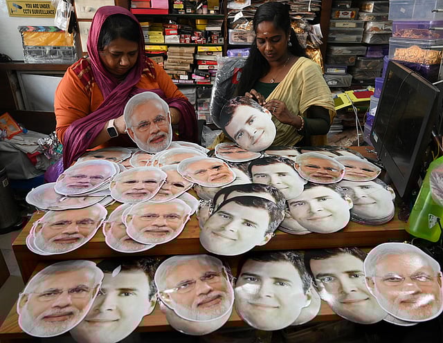 Shopkeepers arranging the facemasks with the photos of Narendra Modi and Rahul Gandhi for sales ahead of Lok Sabha election campaigning