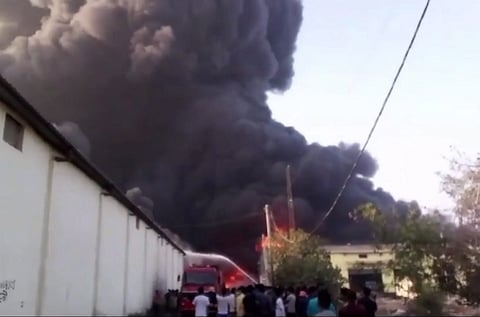 Flames and smoke rise after a fire broke out in a godown at Alipur area, in New Delhi, Monday, March 25, 2024. 