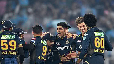 Gujarat Titans' captain Shubman Gill (C) celebrates with teammates after winning the IPL T20 cricket match between Gujarat Titans and Mumbai Indians at the Narendra Modi Stadium in Ahmedabad.