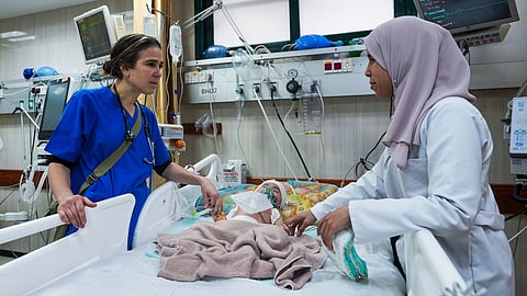 Pediatrician Tanya Haj-Hassan, left, examines wounded children at Al-Aqsa Martyrs Hospital in Deir al-Balah, central Gaza. Saturday, March 16, 2024. 