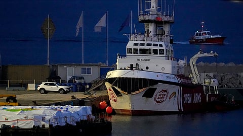 Aid packages are seen left, on a platform near to the docked ship belonging to the Open Arms aid group, as it prepares to ferry some 200 tonnes of rice and flour directly to Gaza, at the port in Larnaca, Cyprus. 