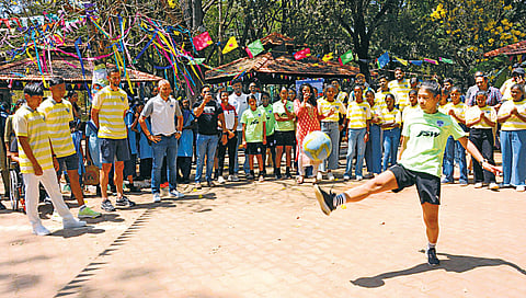 A girl plays football at a Match Day 2024 event, organised to celebrate the power of sports, in Bengaluru on Friday, March 1, 2024. 