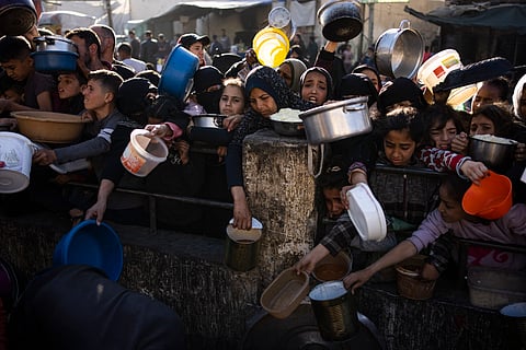 Palestinians line up for a meal in Rafah, Gaza Strip.