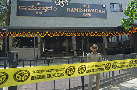 A Police personnel stand guard near the site of a bomb blast at Rameshwaram Cafe. Express/ Allen Egenuse J.