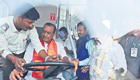 Roads & Buildings Minister Komatireddy Venkat Reddy sits during the launch of electric non-AC TSRTC buses.