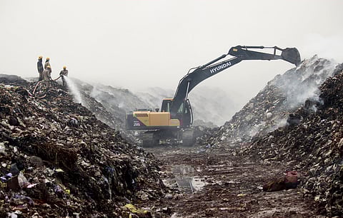 File photo of Fire and Rescue personnel trying to control and douse the fire at the Vellalore dumpyard in Coimbatore last month. 