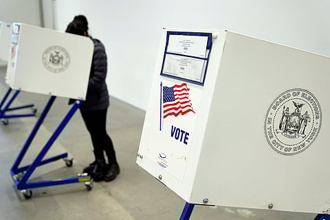 A voter fills out her ballot at a polling site in Manhattan, New York, Tuesday, April 2, 2024.