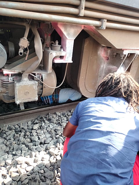 The train went over the man at a slow pace and he got caught under the engine 