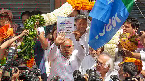 Congress President Mallikarjun Kharge with party leader Jairam Ramesh and others during the launch of the party's 'Ghar Ghar Guarantee Abhiyan' ahead of Lok Sabha elections, in New Delhi.