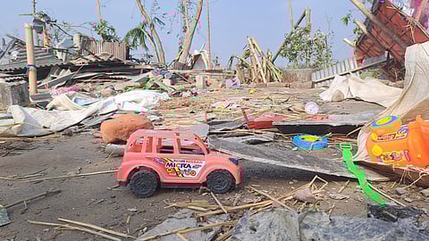 Damaged toys and other items strewn on a road after a storm in Jalpaiguri district, West Bengal, Monday, April 1, 2024. 