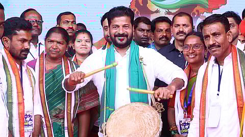 CM A Revanth Reddy plays a drum while campaigning in Adilabad on Monday.