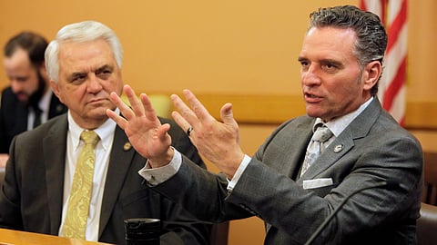Kansas Senate President Ty Masterson, right, R-Andover, briefly discusses tax issues with fellow Republican senators.