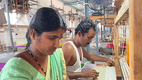 A Kalamkari artist Prasad is seen working on a saree