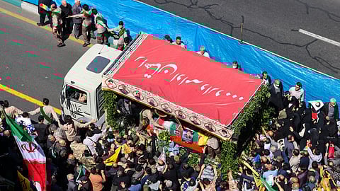 People attend the funeral procession for seven Islamic Revolutionary Guard Corps members killed in a strike in Syria, which Iran blamed on Israel, in Tehran.