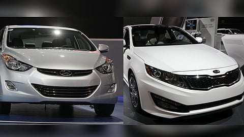 A 2013 Hyundai Elantra Coupe (L) and a 2013 Kia Optima are displayed at the Chicago Auto Show in Chicago.