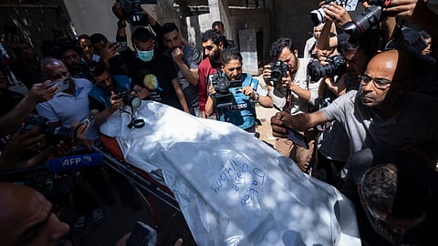 Members of the World Central Kitchen aid group, transports the body of one of the six foreign aid workers who were killed in an Israeli strike, at a hospital morgue in Rafah, Wednesday, April 3, 2024.