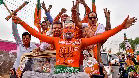 BJP supporters during a road show of Union Minister and BJP leader Arjun Ram Meghwal ahead of Lok Sabha elections, in Bikaner, Wednesday, April 17, 2024. 