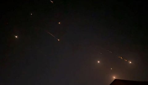 This video grab from AFPTV taken on April 14, 2024 shows explosions lighting up the sky in Hebron in the Israeli-occupied West Bank during an Iranian attack on Israel. 