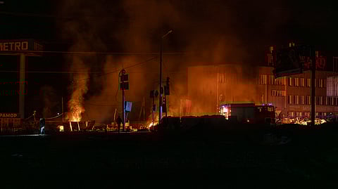 Rescue workers extinguish the fire at the site of a Russian drone attack in Kharkiv, Ukraine, early Saturday April 6, 2024.