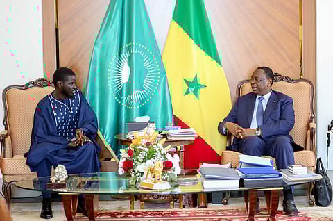 This handout picture taken and distributed by the Senegalese Presidency on March 28, 2024 shows outgoing Senegalese President Macky Sall (R) meeting with Senegal's president-elect Bassirou Diomaye Faye (L) at the Presidential palace in Dakar.