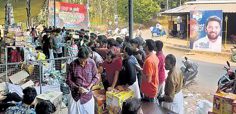Customers in front of a fire-cracker outlet at Keezhariyoor near Meppayur on the eve of Vishu.